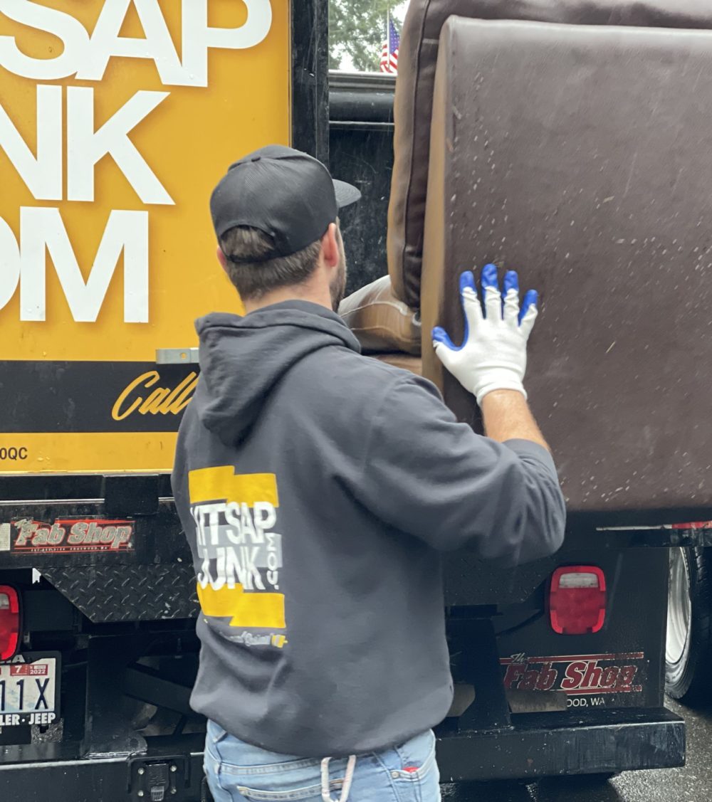 kitsap junk removal crew member hauling junk into truck